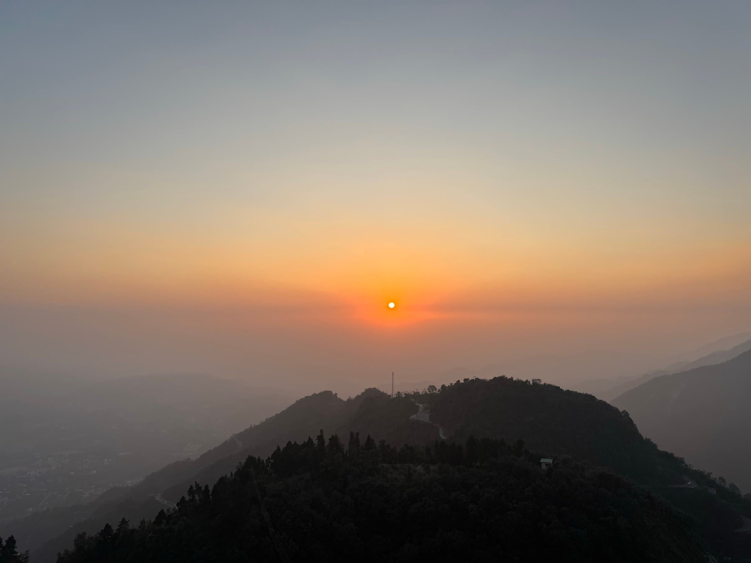 Sunset over misty ridgelines in Mussoorie